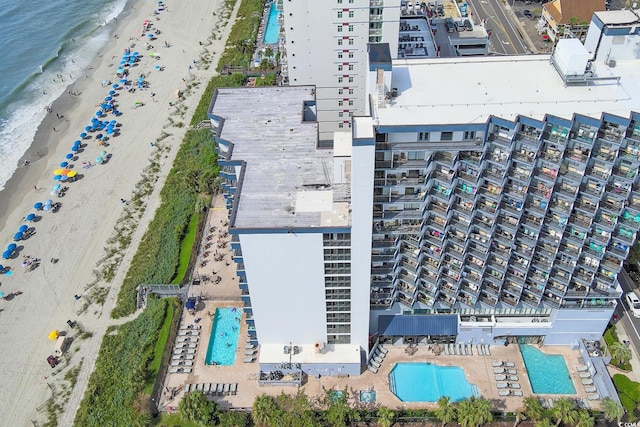drone / aerial view featuring a beach view and a water view