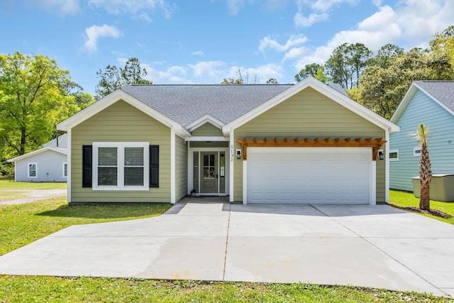 5132 Little River Neck Rd, North Myrtle Beach, SC 29582 - ranch-style home featuring a front lawn, roof with shingles, driveway, and a garage