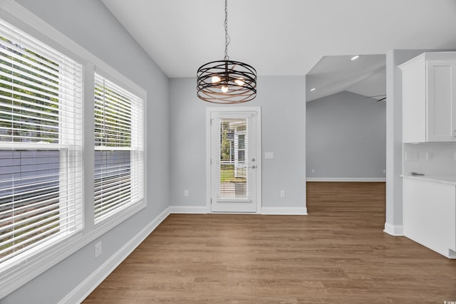 5132 Little River Neck Rd, North Myrtle Beach, SC 29582 - unfurnished dining area featuring a chandelier, lofted ceiling, a wealth of natural light, and light wood-type flooring