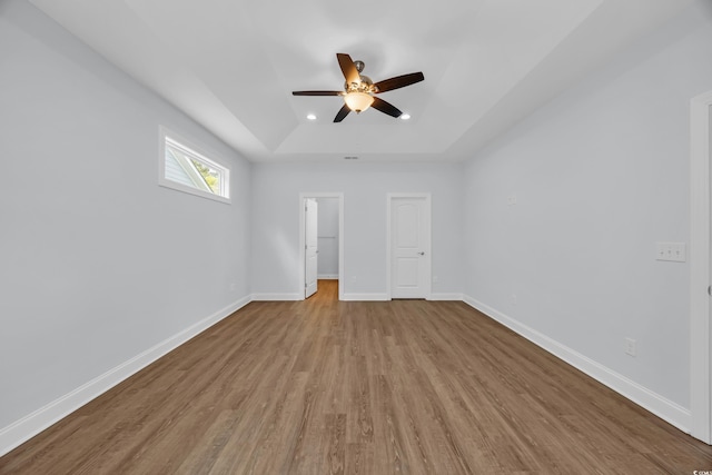 5132 Little River Neck Rd, North Myrtle Beach, SC 29582 - empty room with a tray ceiling, baseboards, a ceiling fan, and wood finished floors