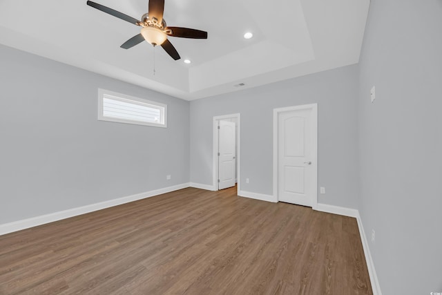 5132 Little River Neck Rd, North Myrtle Beach, SC 29582 - unfurnished bedroom with recessed lighting, baseboards, ceiling fan, wood finished floors, and a raised ceiling