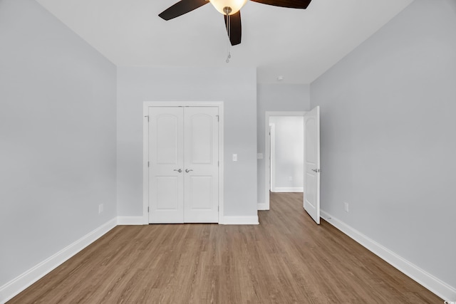 5132 Little River Neck Rd, North Myrtle Beach, SC 29582 - unfurnished bedroom with ceiling fan, a closet, baseboards, and wood finished floors