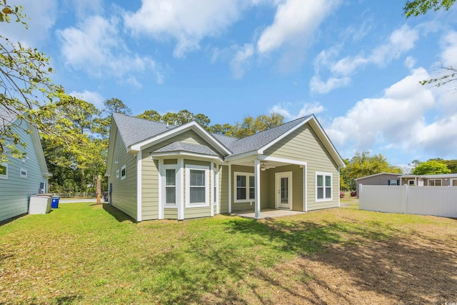 5132 Little River Neck Rd, North Myrtle Beach, SC 29582 - rear view of property featuring a lawn, fence, ceiling fan, a patio area, and roof with shingles