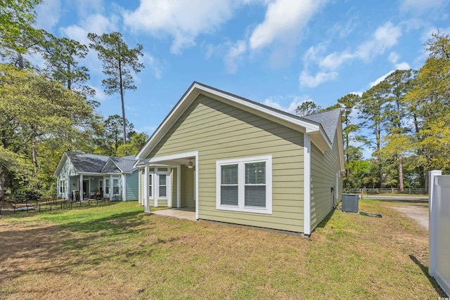 5132 Little River Neck Rd, North Myrtle Beach, SC 29582 - rear view of property with cooling unit, a yard, and fence