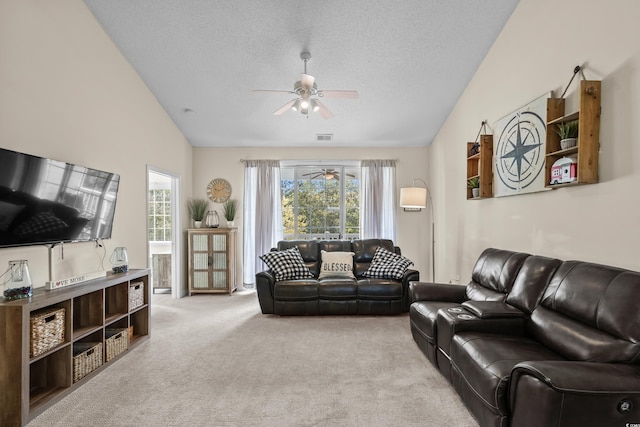 carpeted living area featuring vaulted ceiling, ceiling fan, plenty of natural light, and a textured ceiling