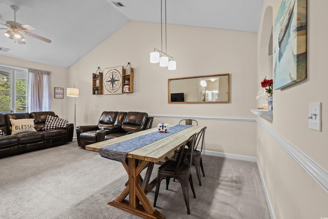 carpeted dining room featuring lofted ceiling, a ceiling fan, and baseboards