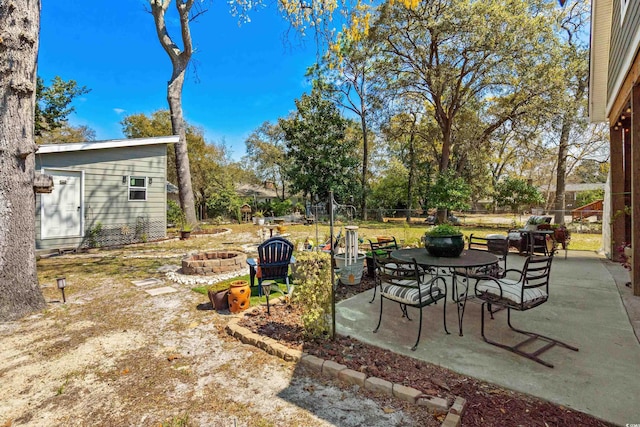 view of yard featuring an outdoor fire pit, a patio area, and fence