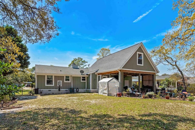 710 Yucca Ave, Myrtle Beach, SC 29577 - back of property featuring a greenhouse, a chimney, and an outdoor structure