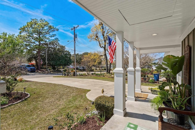 view of green lawn with a porch