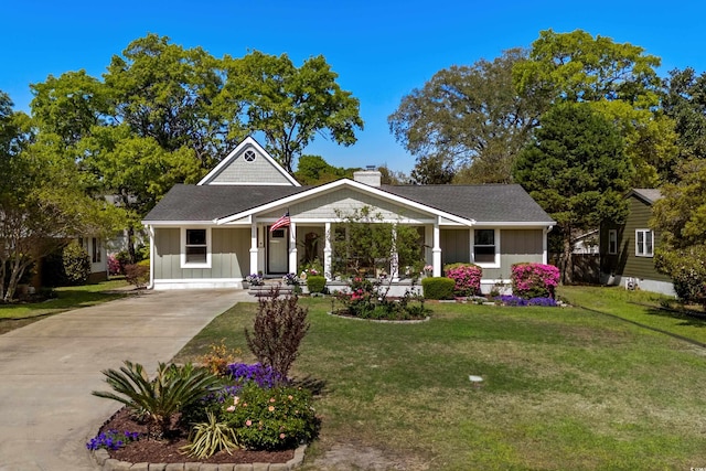 710 Yucca Ave, Myrtle Beach, SC 29577 - view of front facade featuring driveway, board and batten siding, a chimney, and a front lawn