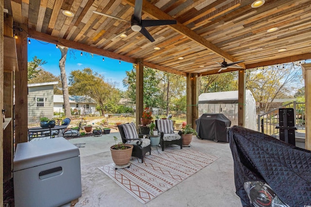 view of patio with a ceiling fan, grilling area, and fence