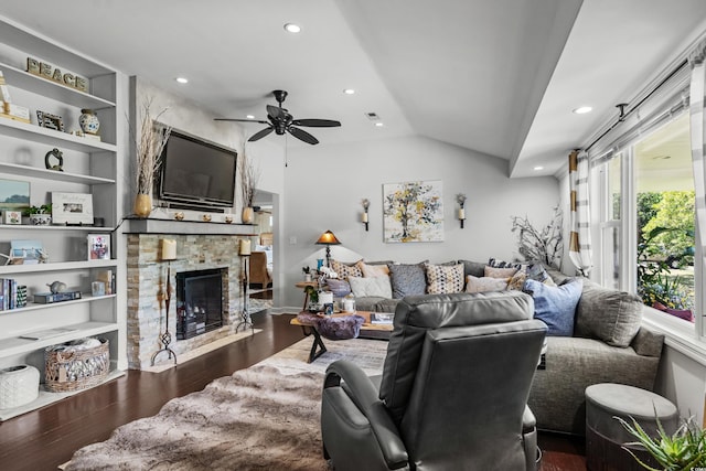 living room featuring vaulted ceiling, wood finished floors, a ceiling fan, a fireplace, and recessed lighting