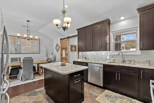 kitchen featuring stainless steel appliances, a sink, a chandelier, decorative backsplash, and lofted ceiling