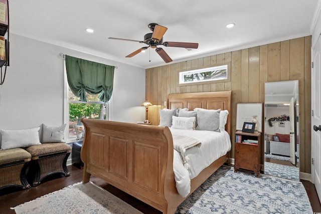 bedroom with ornamental molding, wood finished floors, wood walls, recessed lighting, and a ceiling fan