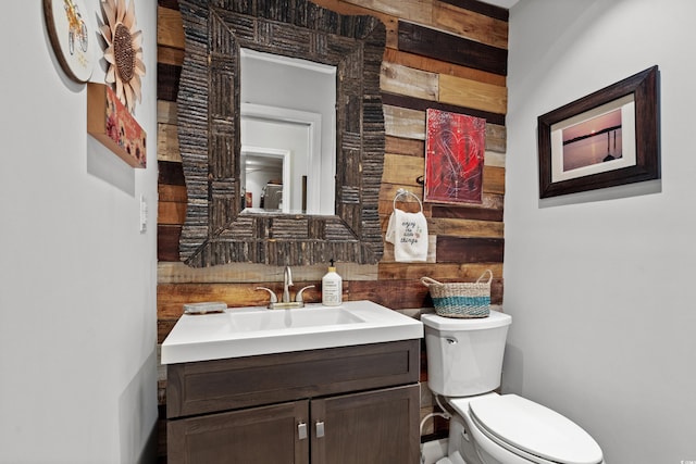 half bathroom featuring toilet and vanity