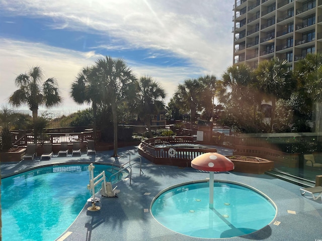 community pool featuring a patio area