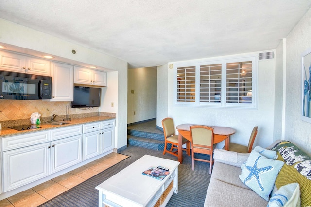 living room featuring visible vents and light tile patterned floors