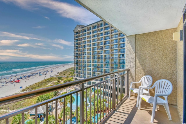 balcony with a beach view and a water view