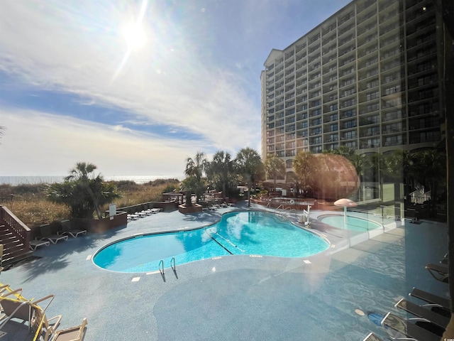 community pool featuring a patio area