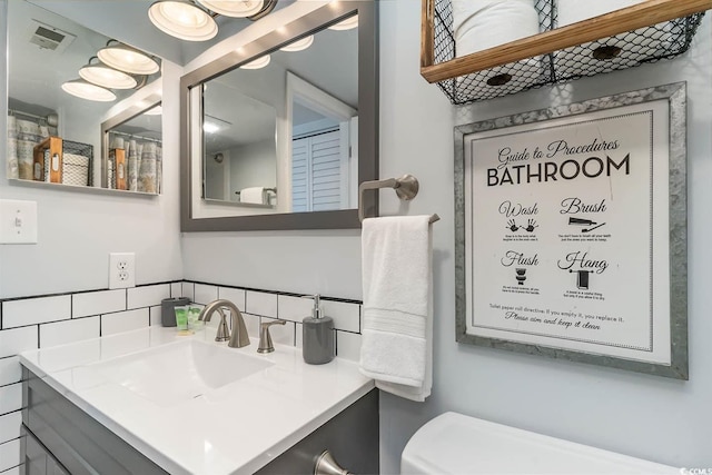 6100 N Ocean Blvd Unit 804, North Myrtle Beach, SC 29582 - bathroom with decorative backsplash, vanity, and toilet