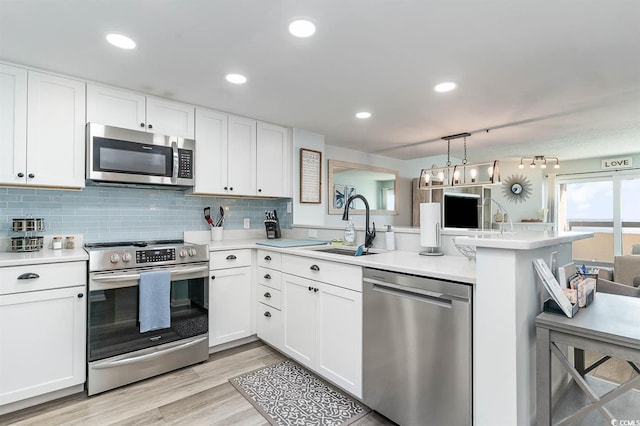 6100 N Ocean Blvd Unit 804, North Myrtle Beach, SC 29582 - kitchen with appliances with stainless steel finishes, a peninsula, a sink, light countertops, and white cabinets