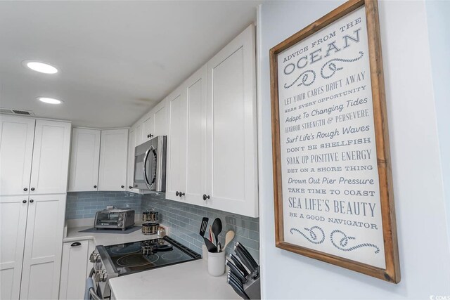 6100 N Ocean Blvd Unit 804, North Myrtle Beach, SC 29582 - kitchen featuring appliances with stainless steel finishes, white cabinetry, tasteful backsplash, light countertops, and recessed lighting