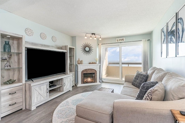 6100 N Ocean Blvd Unit 804, North Myrtle Beach, SC 29582 - living area with a textured ceiling, wood finished floors, and a glass covered fireplace