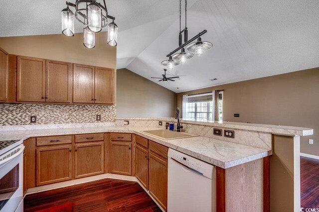 1154 Lampwick Ln, Murrells Inlet, SC 29576 - kitchen with white appliances, a sink, vaulted ceiling, a peninsula, and dark wood-style floors