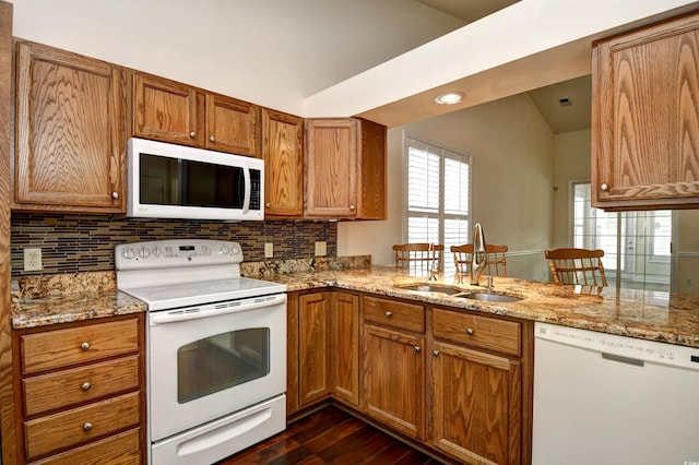 2705 S Key Largo Cir, Myrtle Beach, SC 29577 - kitchen with white appliances, vaulted ceiling, a sink, dark wood-style flooring, and brown cabinetry