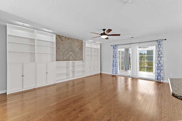 356 Whipple Run Loop, Myrtle Beach, SC 29588 - unfurnished living room featuring a textured ceiling, ceiling fan, wood finished floors, and built in features