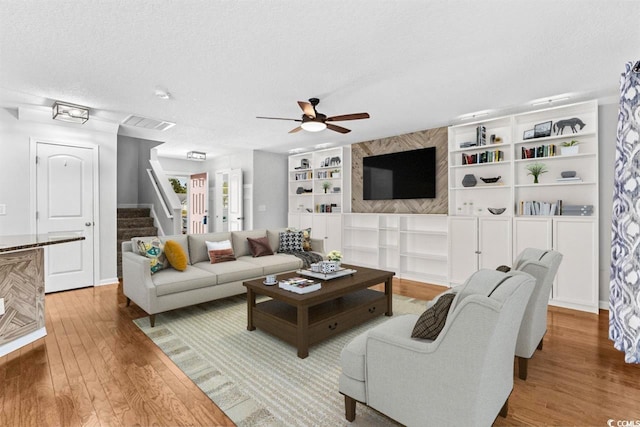 356 Whipple Run Loop, Myrtle Beach, SC 29588 - living room featuring stairs, wood finished floors, a ceiling fan, a textured ceiling, and built in shelves