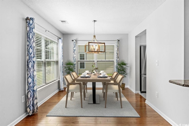 356 Whipple Run Loop, Myrtle Beach, SC 29588 - dining area with wood finished floors, a chandelier, and a textured ceiling