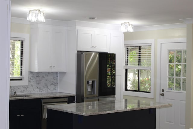 880 Briarwood Dr, Myrtle Beach, SC 29572 - kitchen with appliances with stainless steel finishes, a chandelier, light stone counters, backsplash, and white cabinetry