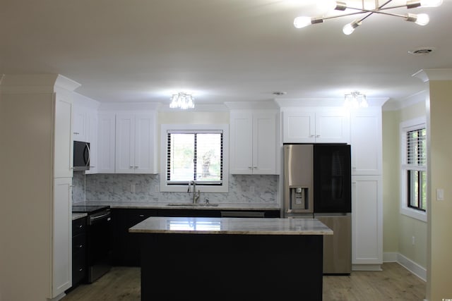 880 Briarwood Dr, Myrtle Beach, SC 29572 - kitchen featuring a chandelier, appliances with stainless steel finishes, a center island, light wood-style floors, and crown molding