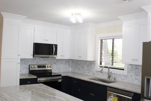 880 Briarwood Dr, Myrtle Beach, SC 29572 - kitchen featuring appliances with stainless steel finishes, light stone counters, tasteful backsplash, and white cabinetry