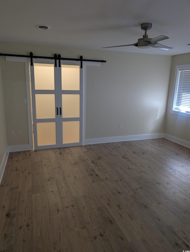 880 Briarwood Dr, Myrtle Beach, SC 29572 - spare room with a barn door, wood finished floors, and a ceiling fan