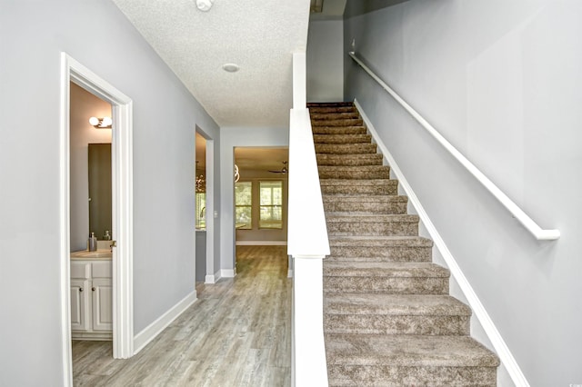 121 Olde Towne Way Unit 2, Myrtle Beach, SC 29588 - stairway featuring a textured ceiling, baseboards, and wood finished floors