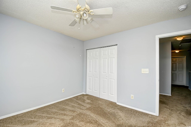 121 Olde Towne Way Unit 2, Myrtle Beach, SC 29588 - unfurnished bedroom featuring a closet, baseboards, carpet flooring, and a textured ceiling
