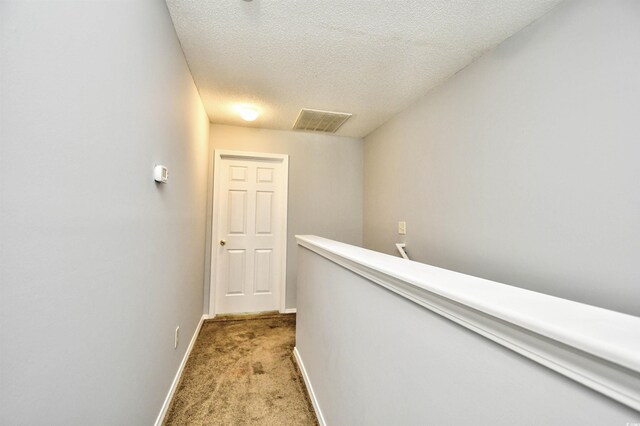 121 Olde Towne Way Unit 2, Myrtle Beach, SC 29588 - hallway with light colored carpet, a textured ceiling, baseboards, an upstairs landing, and visible vents