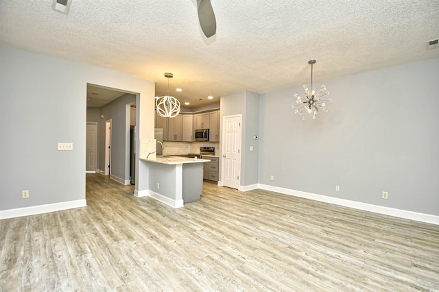 121 Olde Towne Way Unit 2, Myrtle Beach, SC 29588 - kitchen featuring a chandelier, appliances with stainless steel finishes, light countertops, open floor plan, and light wood-style floors