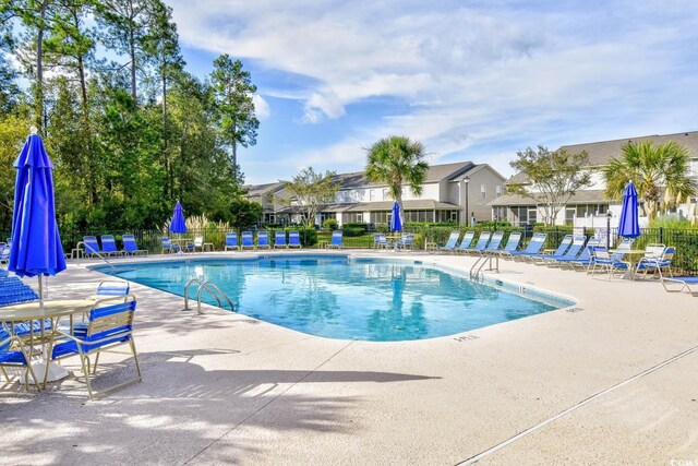 121 Olde Towne Way Unit 2, Myrtle Beach, SC 29588 - pool with a patio, fence, and a residential view