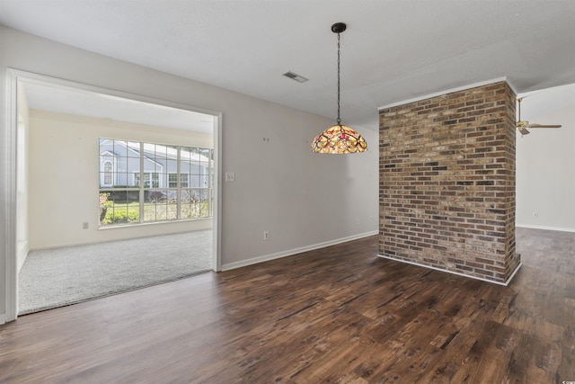 unfurnished room featuring wood finished floors, baseboards, and visible vents