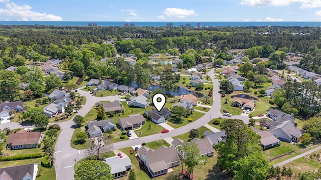 birds eye view of property with a water view and a residential view