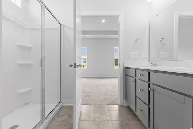 full bathroom with a stall shower, baseboards, vanity, recessed lighting, and tile patterned flooring