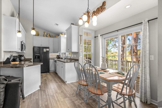 6001-8050 S Kings Hwy, Myrtle Beach, SC 29575 - kitchen with white cabinets, stainless steel appliances, an inviting chandelier, visible vents, and light wood-style flooring