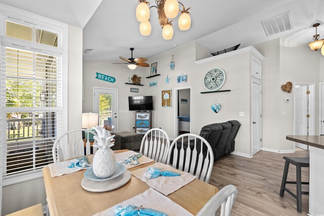 6001-8050 S Kings Hwy, Myrtle Beach, SC 29575 - dining area with light wood finished floors, vaulted ceiling, visible vents, baseboards, and ceiling fan with notable chandelier