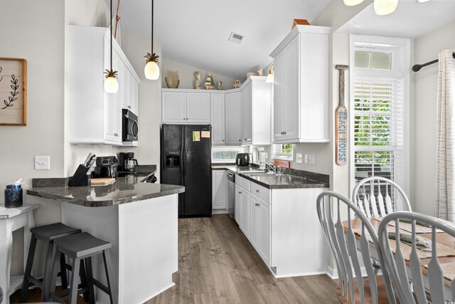 6001-8050 S Kings Hwy, Myrtle Beach, SC 29575 - kitchen with stainless steel appliances, wood finished floors, visible vents, and a peninsula