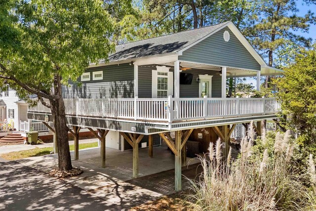 6001-8050 S Kings Hwy, Myrtle Beach, SC 29575 - exterior space with a carport, a wooden deck, driveway, and roof with shingles