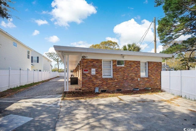 706 Mitchell Dr, Myrtle Beach, SC 29577 - rear view of property featuring a patio, brick siding, and asphalt driveway