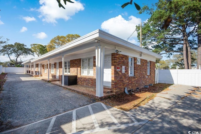 706 Mitchell Dr, Myrtle Beach, SC 29577 - view of property exterior with covered porch and brick siding